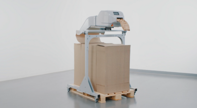 
				Machine producing paper cushions for packaging.