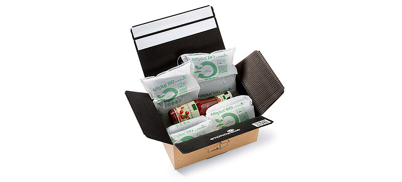 Open cardboard box with protective air cushions