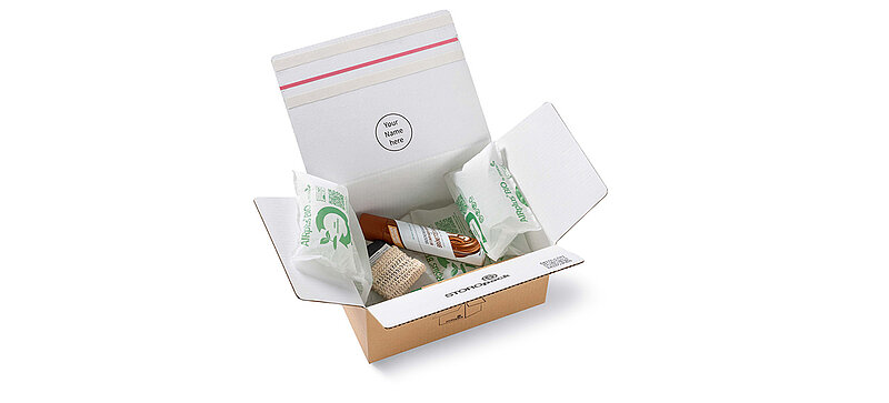 Open cardboard box with protective air cushions