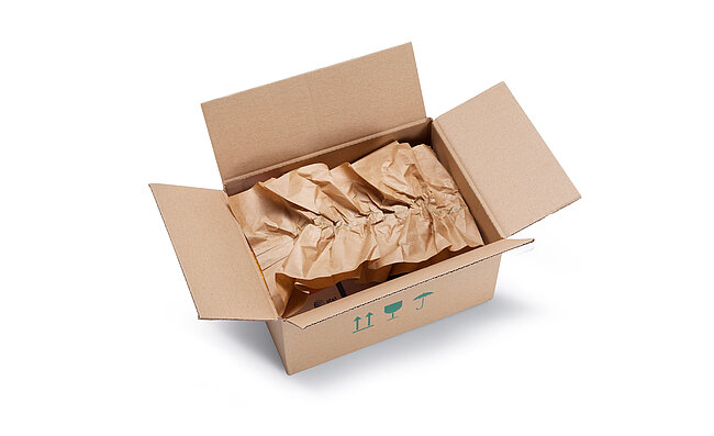 A cardboard box containing brown paper cushioning