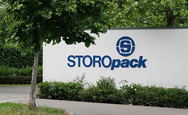 A white wall with blue Storopack logo