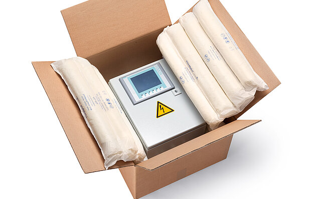 A cardboard box containing an electrical enclosure and foam packaging