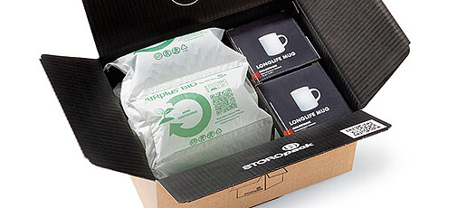 
				Open cardboard box with protective air cushions