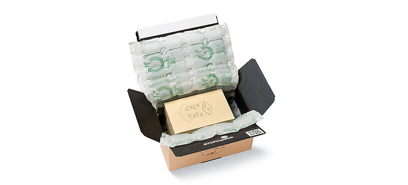 Open cardboard box with protective air cushions