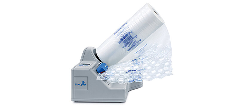 
		  Eine kompakte graue Maschine befüllt Luftpolsterfolie mit Luft