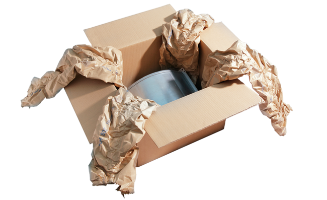A cardboard box containing a component and brown paper cushioning