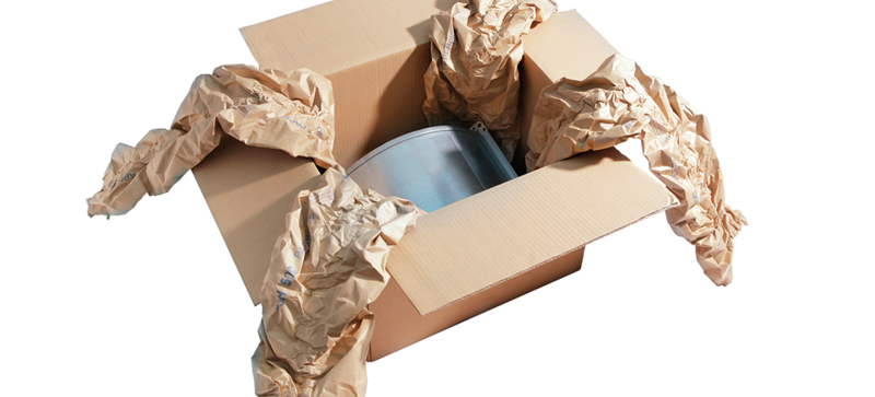 
		  A cardboard box containing a component and brown paper cushioning