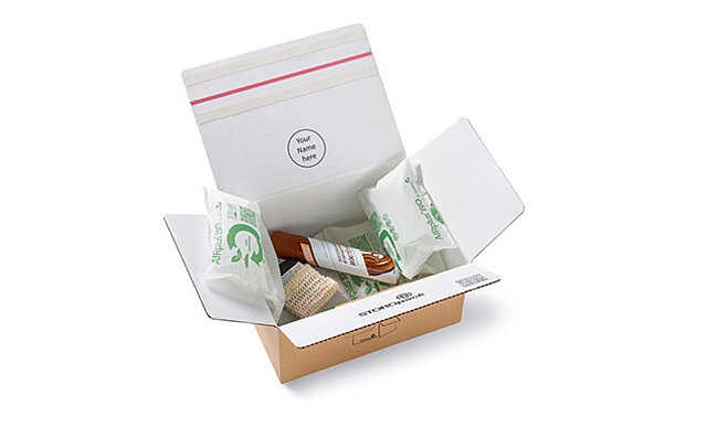 Open cardboard box with protective air cushions